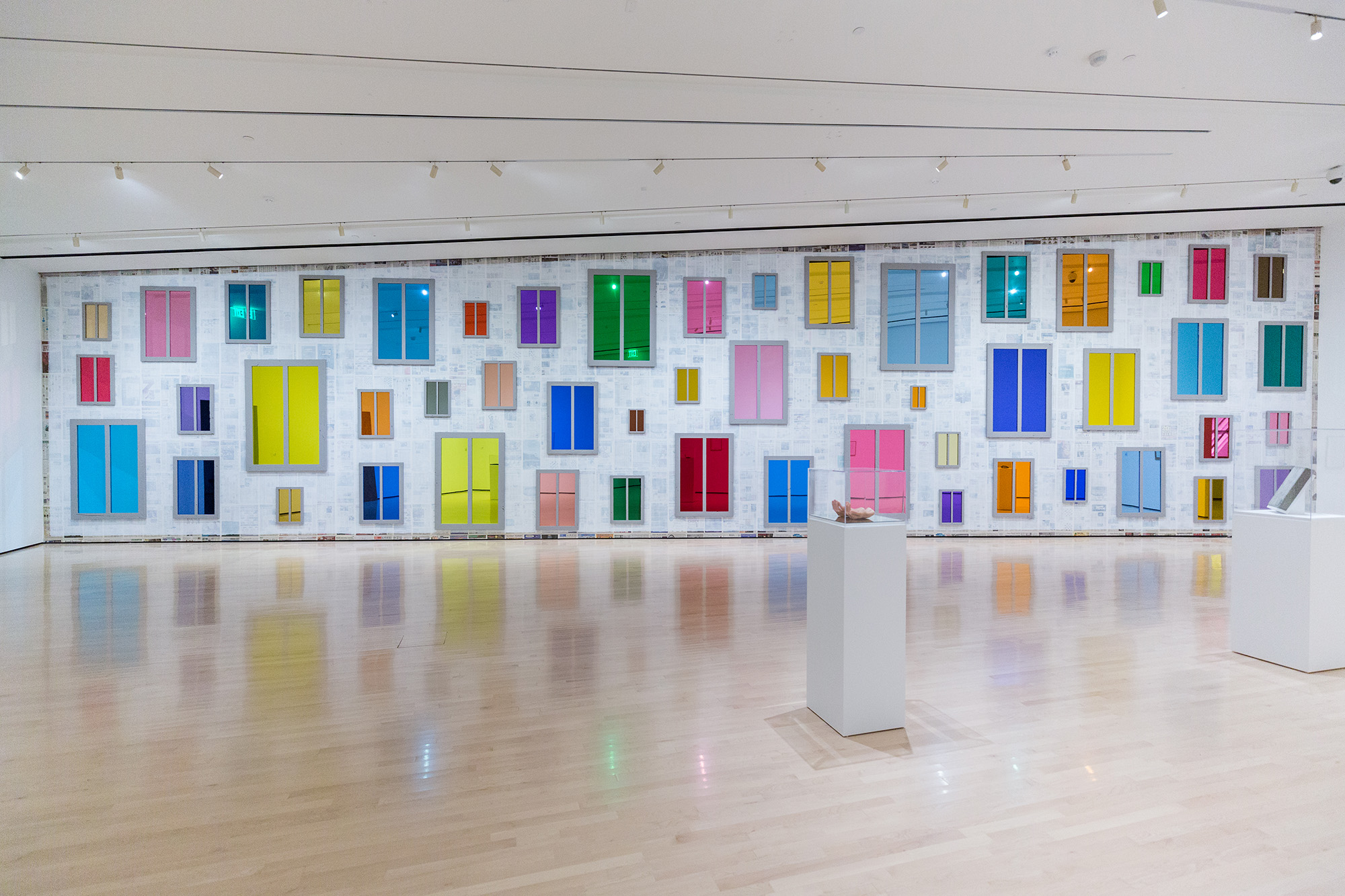 L to R: Ugo Rondinone, <i>​Clockwork for Oracles II</i>​, 2008, courtesy the artist and Gladstone Gallery, New York and Brussels; Jonathan Monk, ​<i>Second Hand Daily Exchange</i>​, 2006, courtesy the artist and Lisson Gallery, New York and London; Wolf Vostell, ​<i>Betonbuch​ (Concrete Book)</i>, 1971, University of Chicago Library, Special Collections Research Center; installation view at the MSU Broad, 2017. Photo: MSU Broad